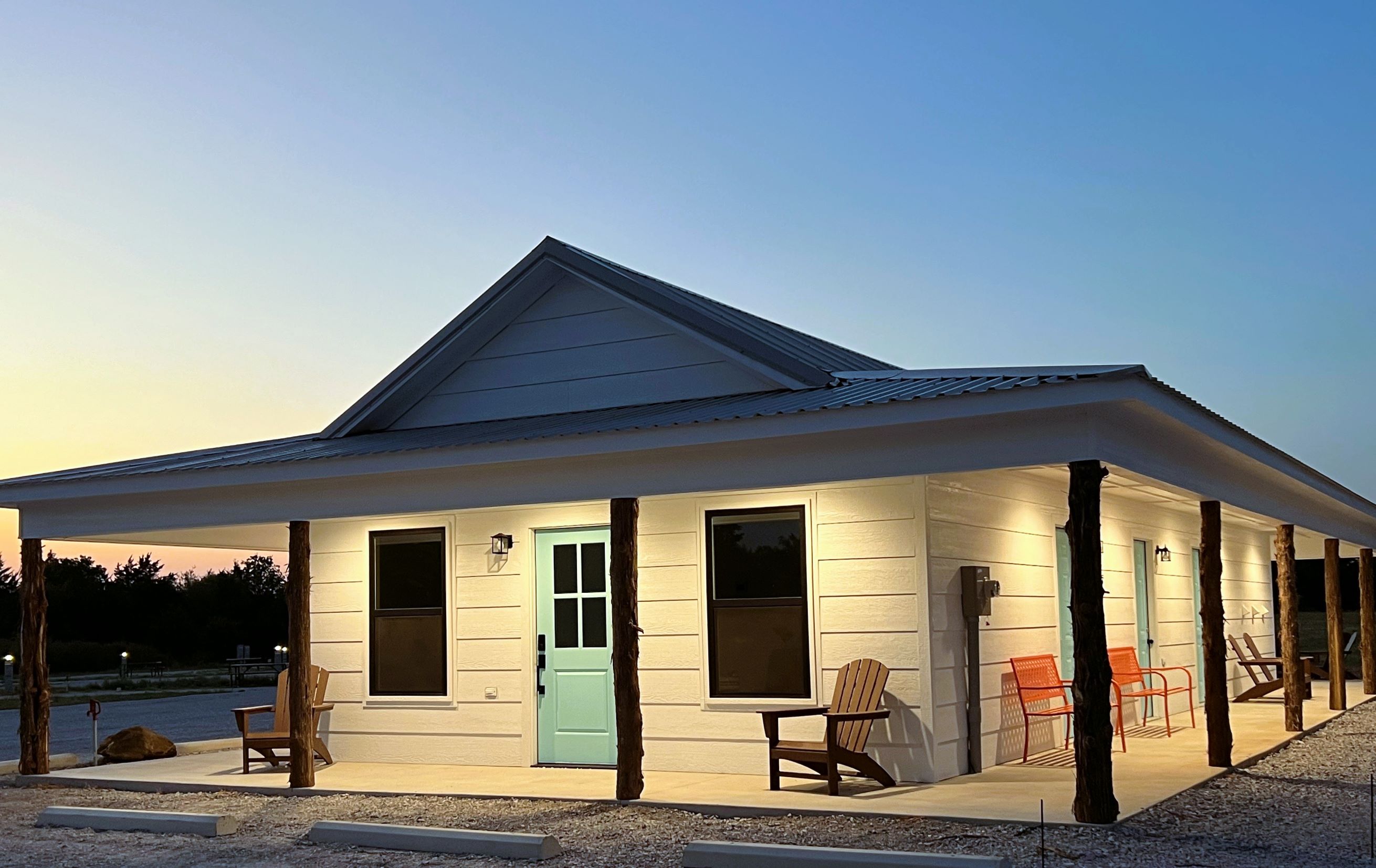 Roadrunner Ranch RV Resort building at dusk with warm lighting in Marietta Oklahoma